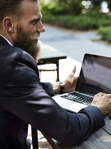 Auditor reviewing financial data on a laptop